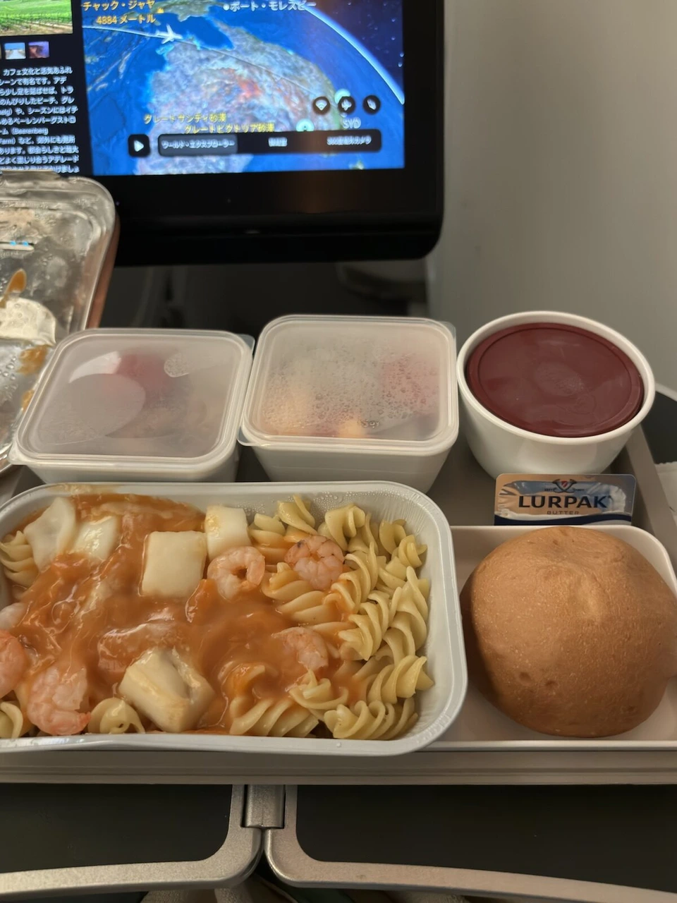 CX139の2回目の機内食。えびとイカのトマトソースのフジッリ、パン、ルアパックのバター
