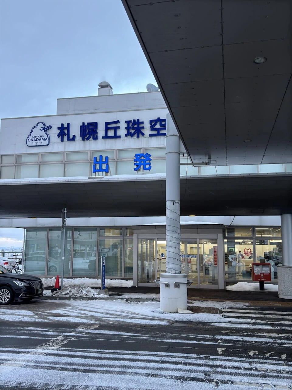 札幌丘珠空港ターミナルの出発口。屋根の看板に札幌丘珠空港 出発
