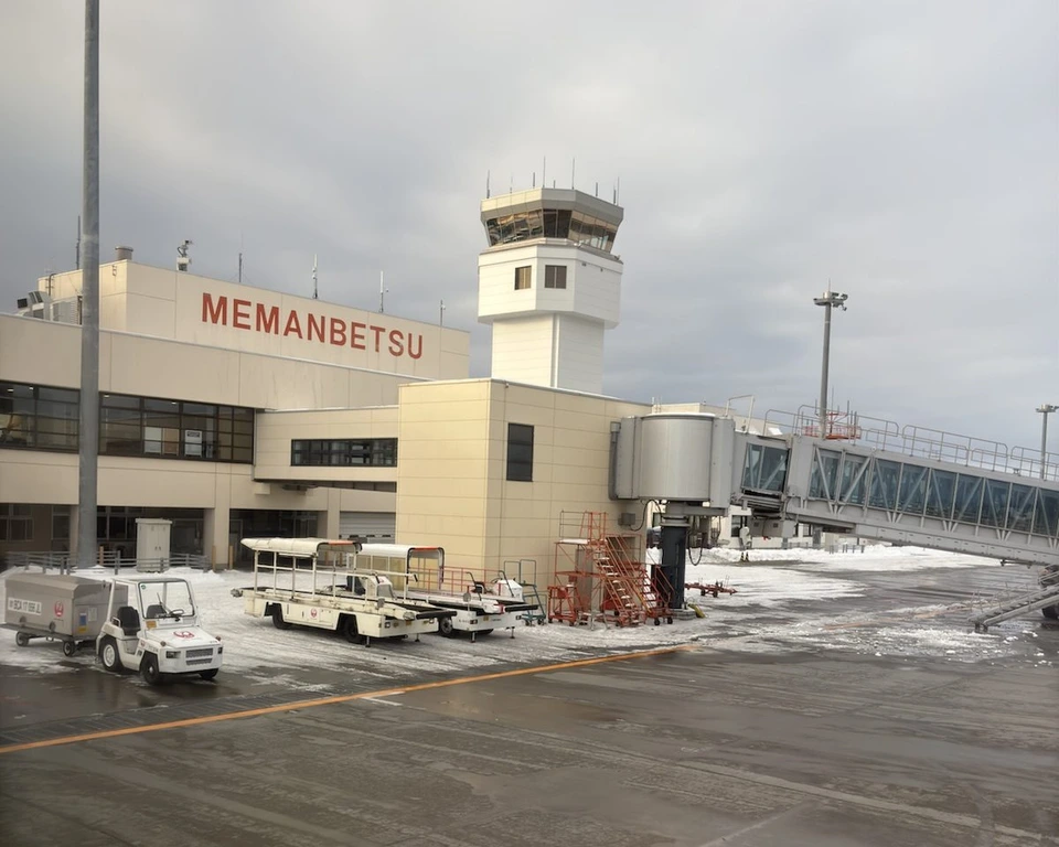 駐機場側から見た女満別空港のターミナル。MEMANBETSUの文字と管制塔、雪の残る駐機場