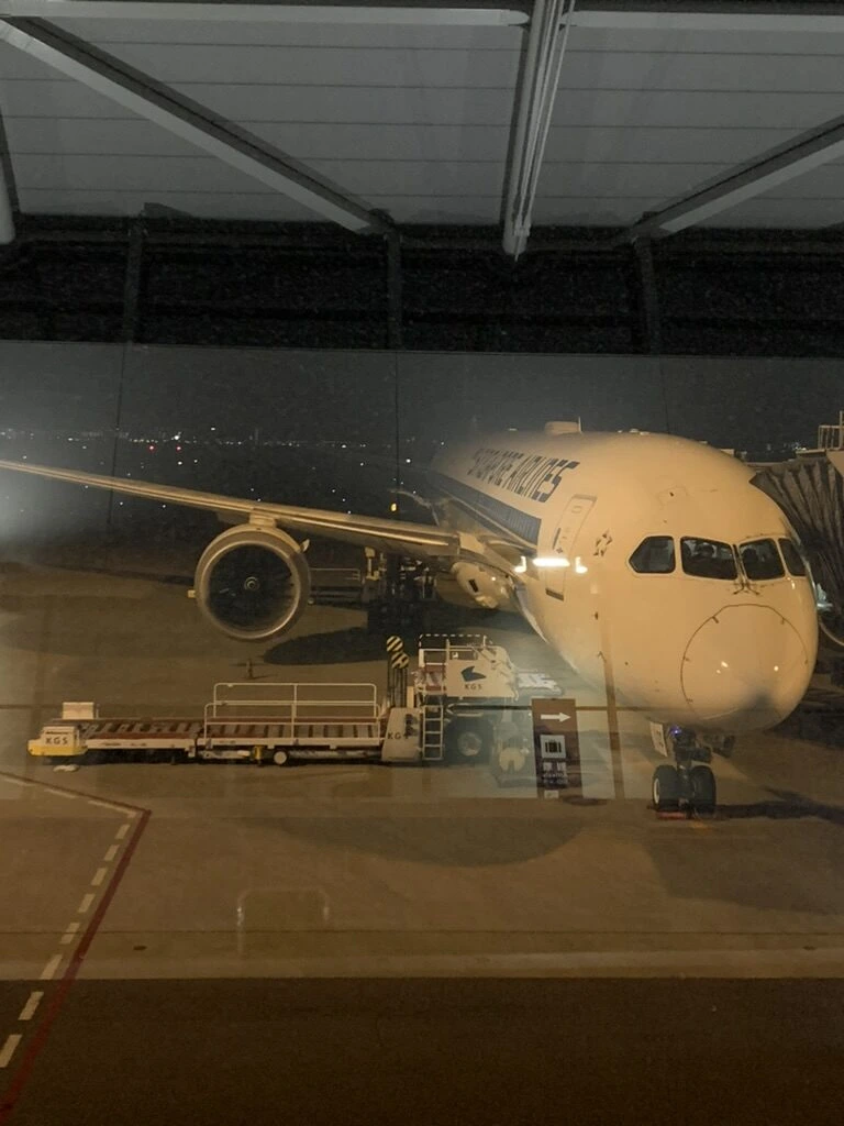 関空の搭乗口のガラス越しに正面から見た夜のシンガポール航空787-10