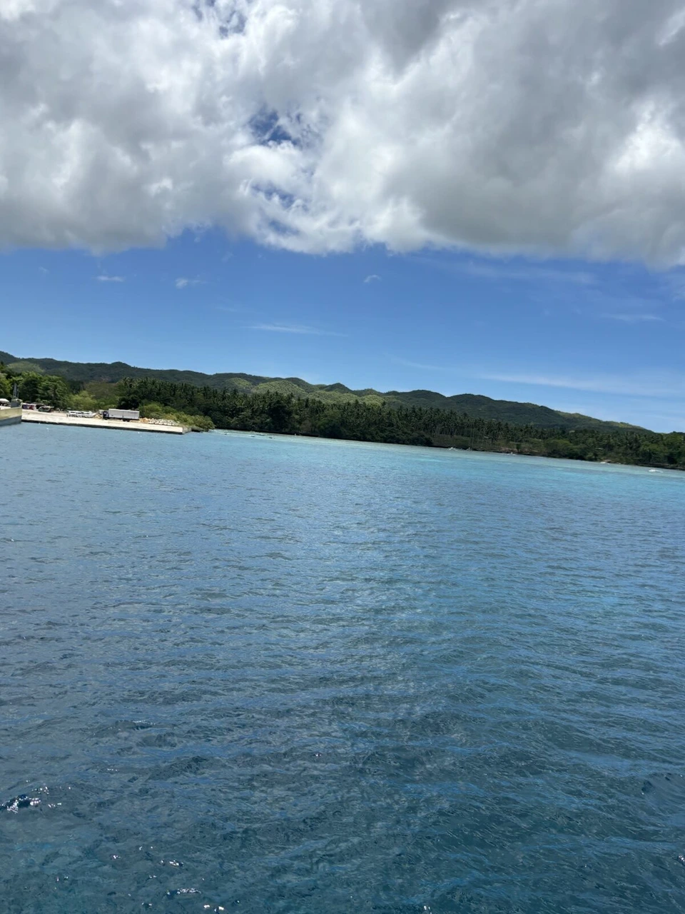 青い空と雲の下に横たわるカモテス諸島の島影