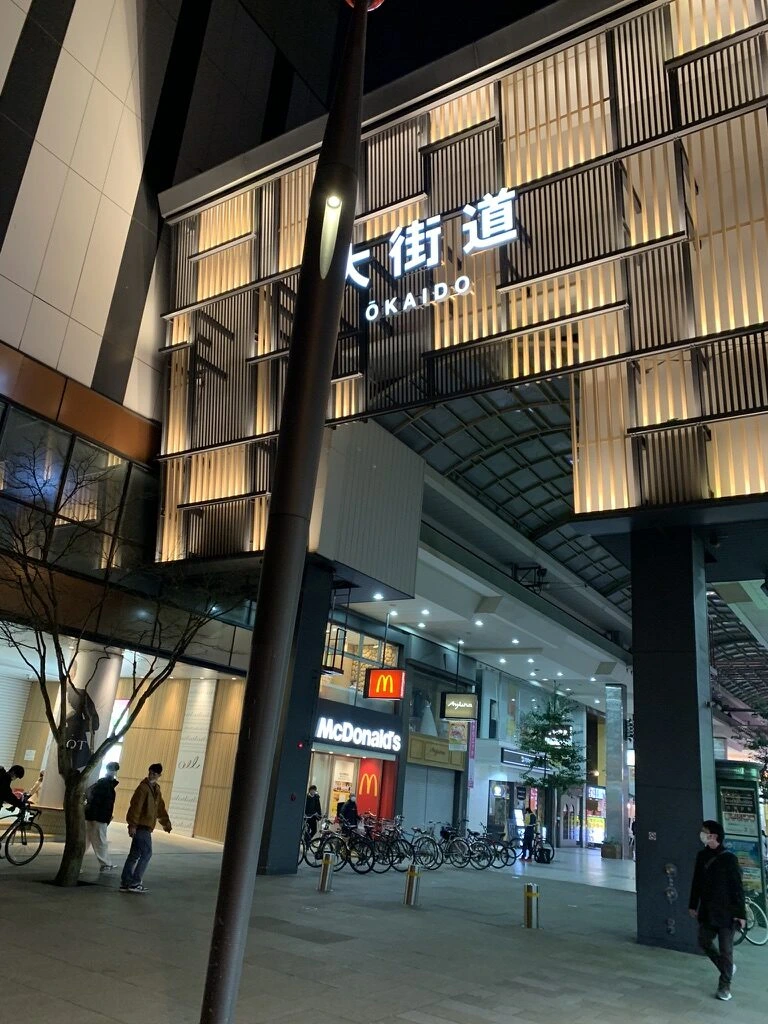 ライトアップされた大街道アーケードの入口。格子模様の外壁に「大街道 OKAIDO」の文字