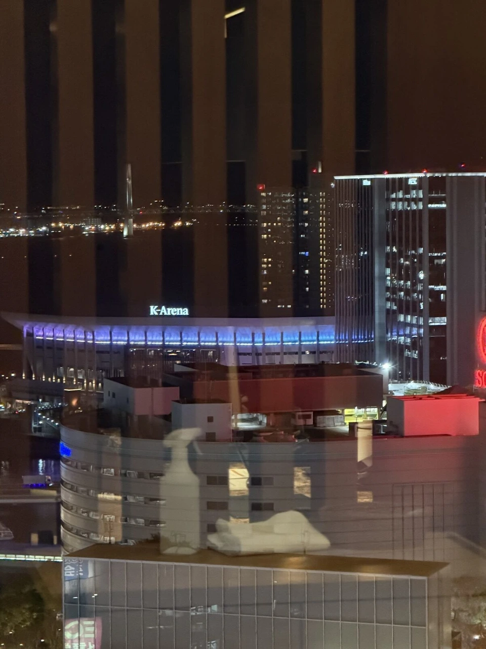 横浜ベイシェラトンのジュニアスイートの窓から見た夜の横浜。青くライトアップされたKアリーナと周りのビル