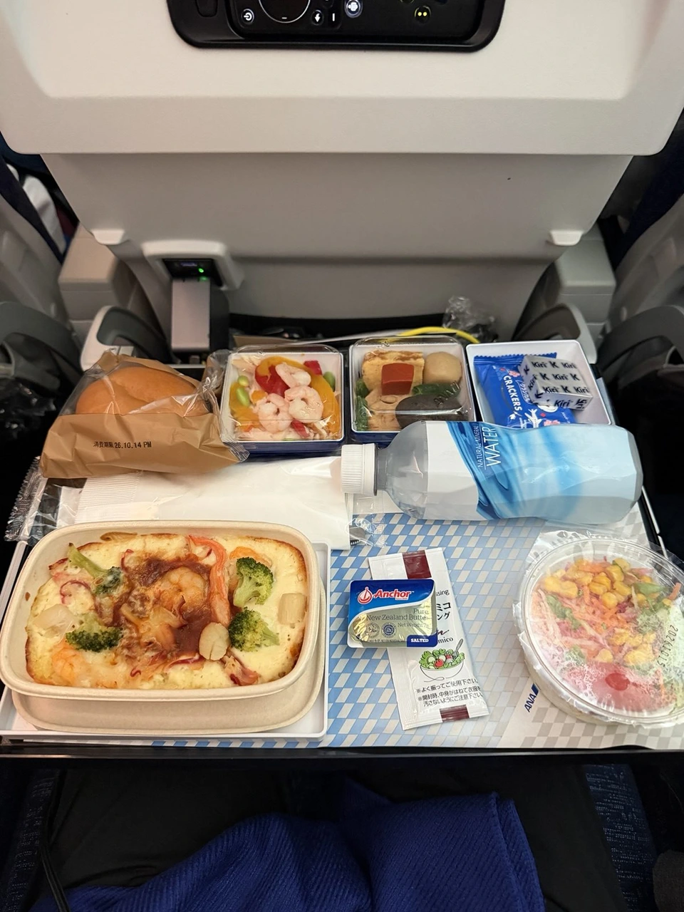 NH847エコノミーの機内食。グラタン、サラダ、パン、デザートのトレー