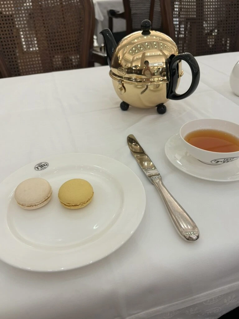 クアラルンプールのTWGの金色のティーポットと紅茶、マカロン2個