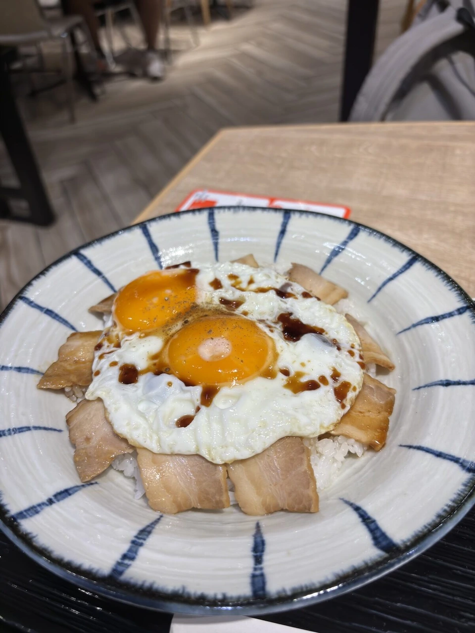 松山空港で食べた、ご飯の上に焼豚を並べて目玉焼き2つとたれをかけた丼