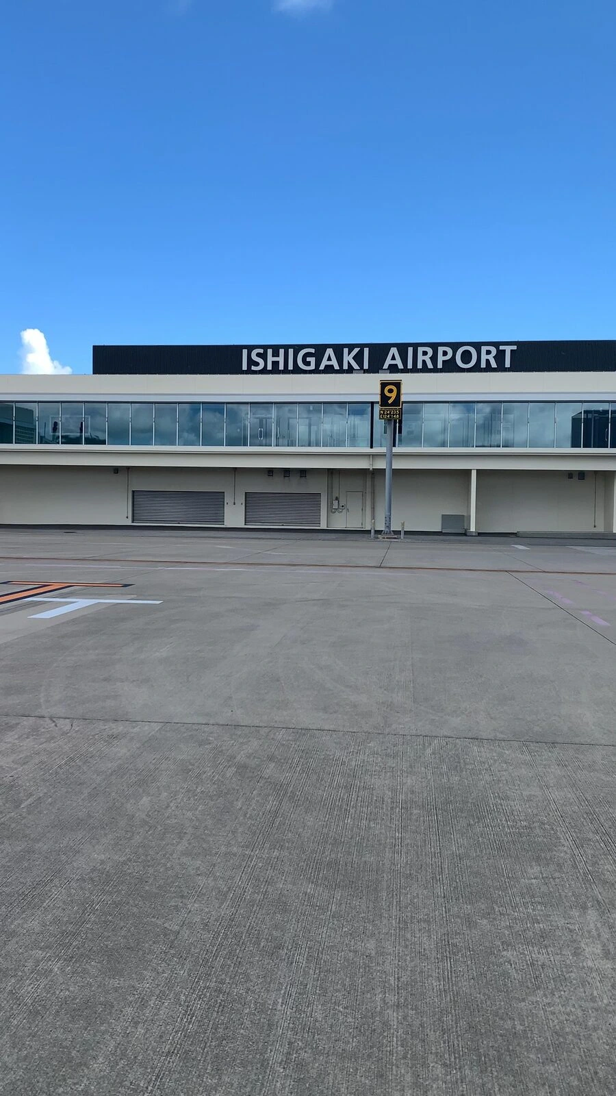 駐機場から見た南ぬ島 石垣空港のターミナル。ISHIGAKI AIRPORTの文字